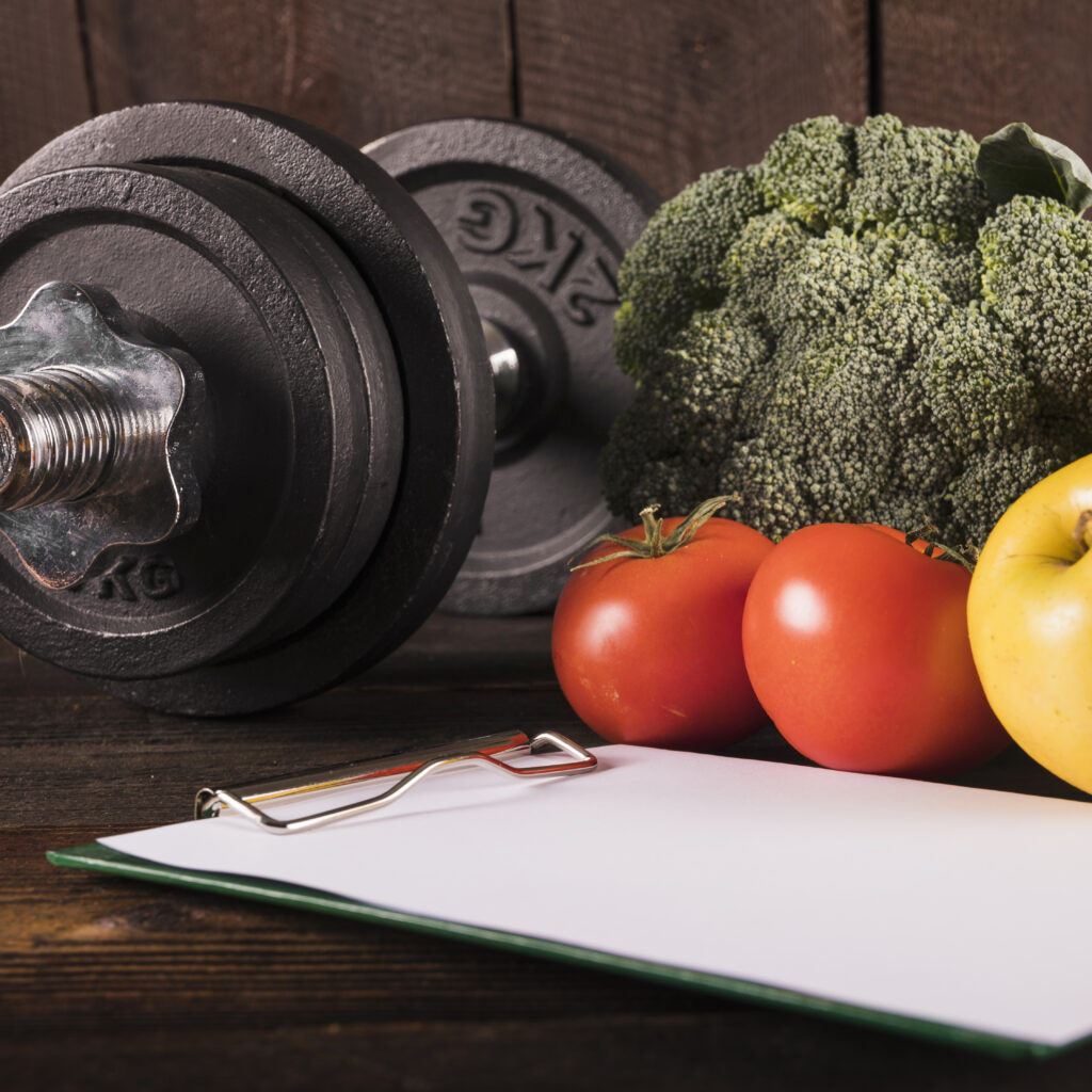 close up healthy raw food dumbbell wooden desk