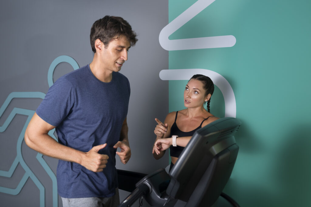 medium shot woman helping fit man gym