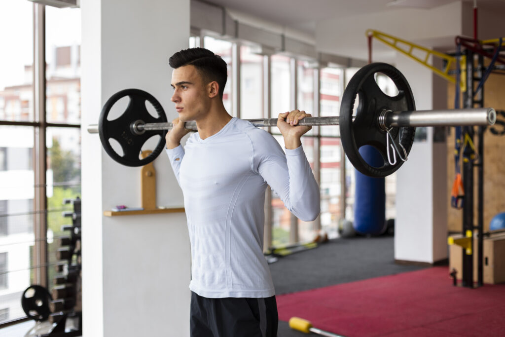 young man fitness class lifting weights